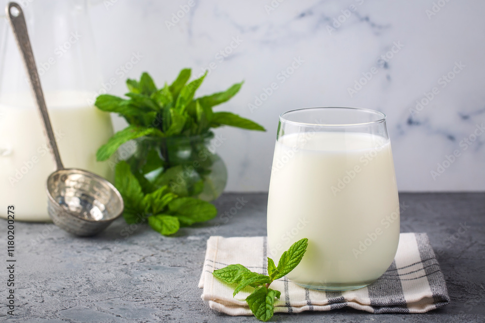 Glass cup of Turkish traditional drink ayran , kefir or buttermilk made from yogurt, healthy food