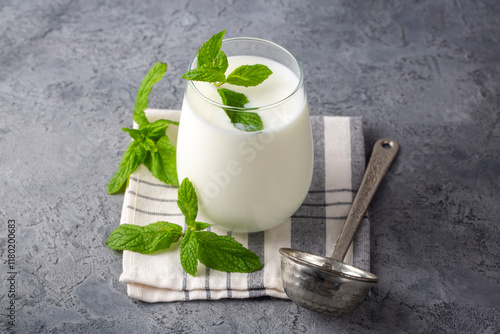 Glass cup of Turkish traditional drink ayran , kefir or buttermilk made from yogurt, healthy food