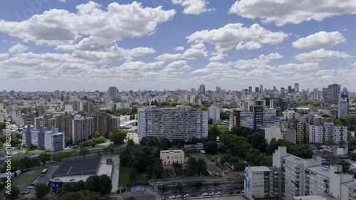 Wallpaper Mural Drone flies over large square apartment building toward Lezama Park and downtown on partially cloudy day in Buenos Aires, Argentina Torontodigital.ca