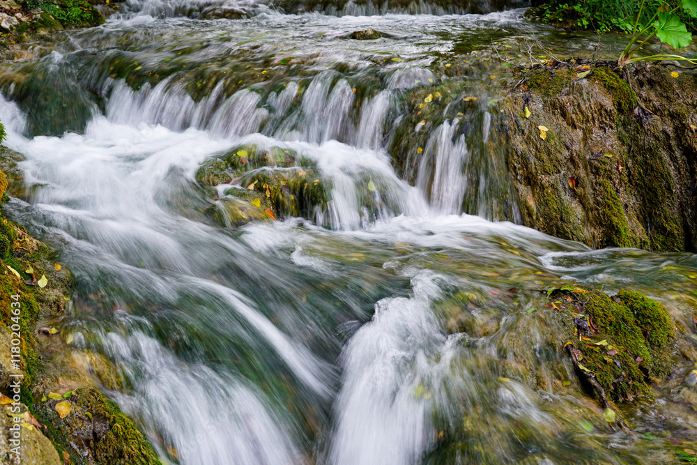 Low shutter speed shot of beautiful waterfall from hiking trail in Plitvice lakes national park Low shutter speed shot of beautiful waterfall from hiking trail in Plitvice lakes national park