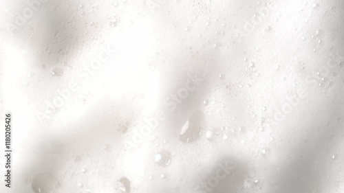 Hair foam mousse rotation, macro. Beauty background. Close up of white cloud of hair mousse or shaving foam. Soap suds