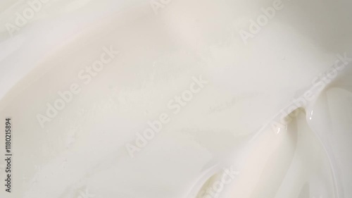 A woman takes a white face cream from a glass jar with her finger, macro. The concept of skin care for the body and face.