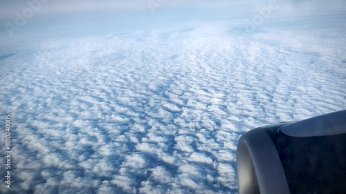 A view from a plane's porthole on the horizon when flying in the sky between layers of clouds (altocumulus clouds, stratus clouds)