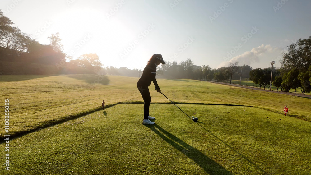 Woman playing golf on beautiful course , swinging and hitting golf ball , luxury vacation