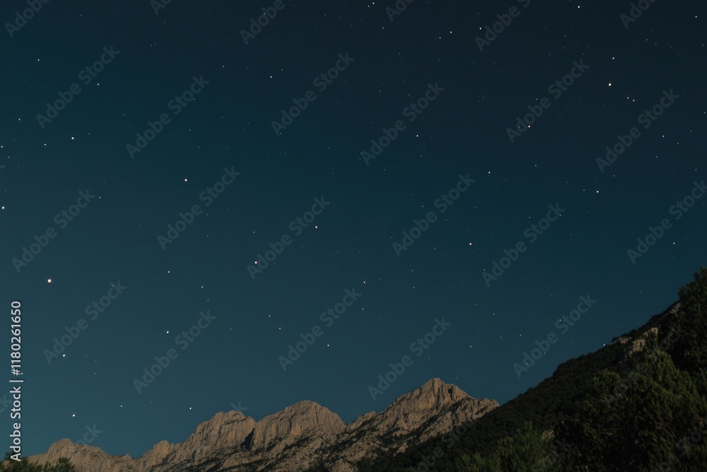 Fototapeta premium A view of a mountain under a starry night sky