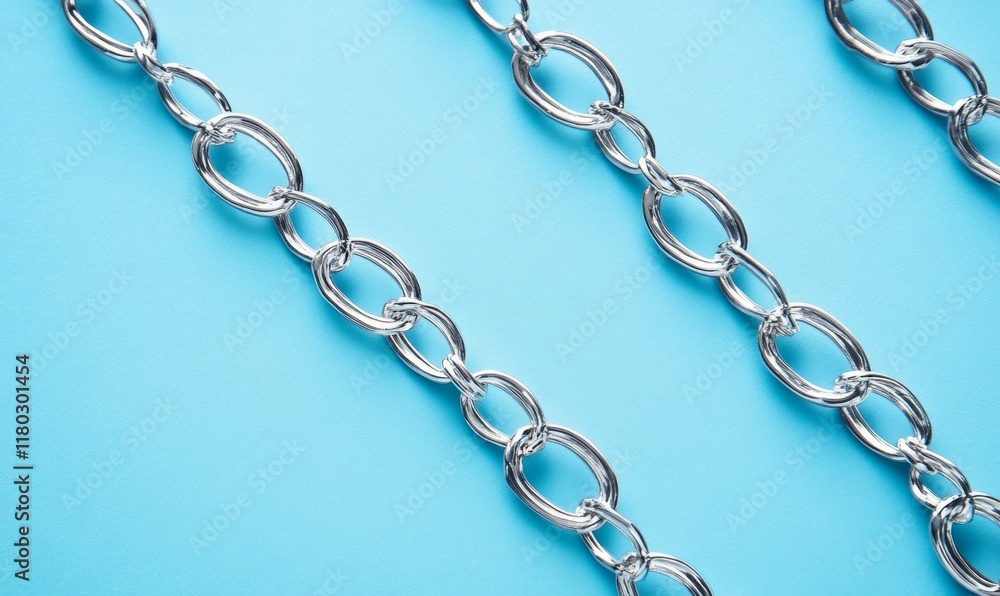 Fototapeta premium Close up of intricate metal chain on blue background, symbolizing connection