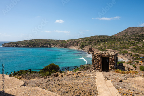 Fototapeta Naklejka Na Ścianę i Meble -  Landscape of the coast of the island of Sant'Antioco with the turquoise sea and the red cliffs on a sunny day