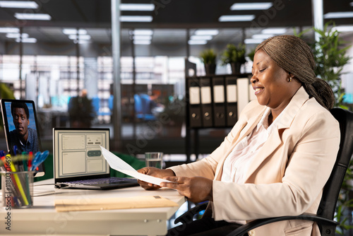 Businesswoman holding teleconference meeting with HR, liaising to recruit, train and guide staff. Team leader instructing human resources worker in online remote videocall using tablet photo