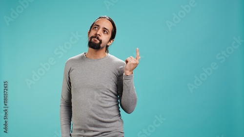 Cheerful man acting casually, exuding nonchalant and carefree demeanor. Portrait of jolly person being relaxed and at ease, showing self assuredness, studio background, camera B photo