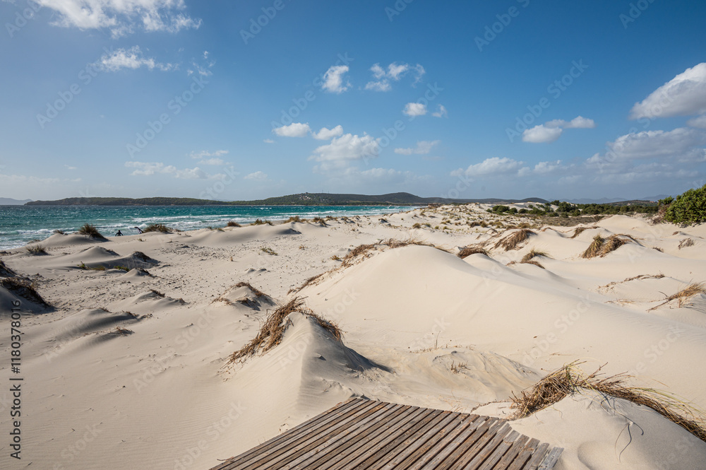 The beautiful beach of Is Solinas in Sardinia with its high white dunes on a windy day