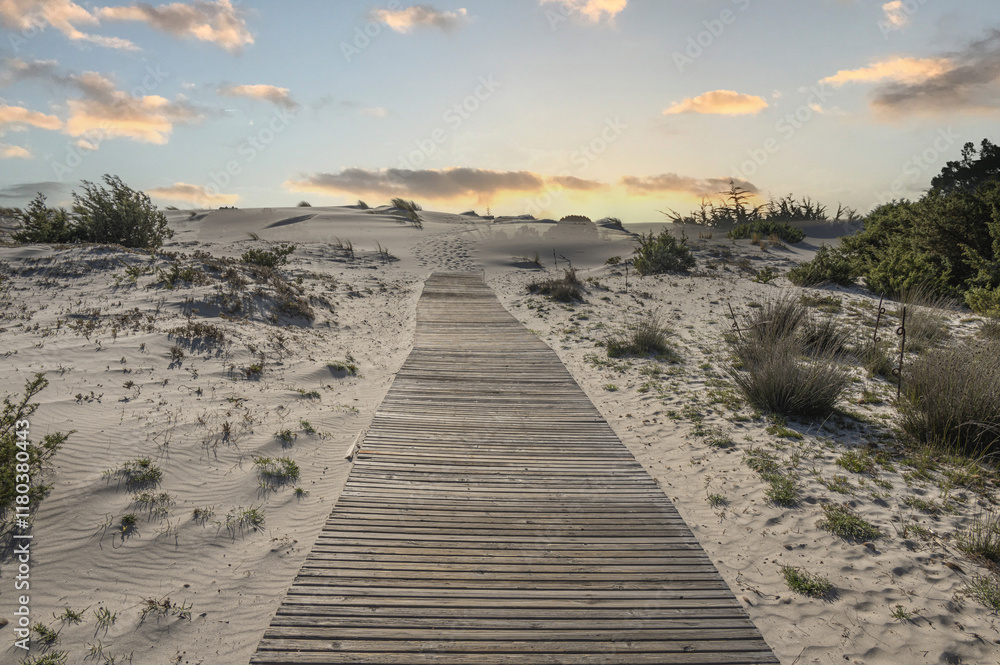 The path to the beautiful beach of Is Solinas in Sardinia with its high white dunes on sunset