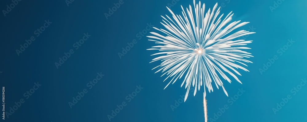 Fototapeta premium A vibrant firework explodes against a serene blue background, showcasing delicate sparks radiating outward, creating a festive and celebratory atmosphere.