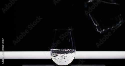 Streaming Water Into A Clear Glass photo