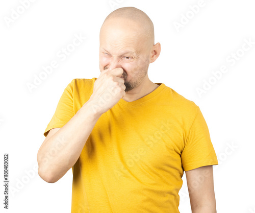 Obraz na plátne Disgusted Man in Yellow Shirt Holding Nose with Unpleasant Expression