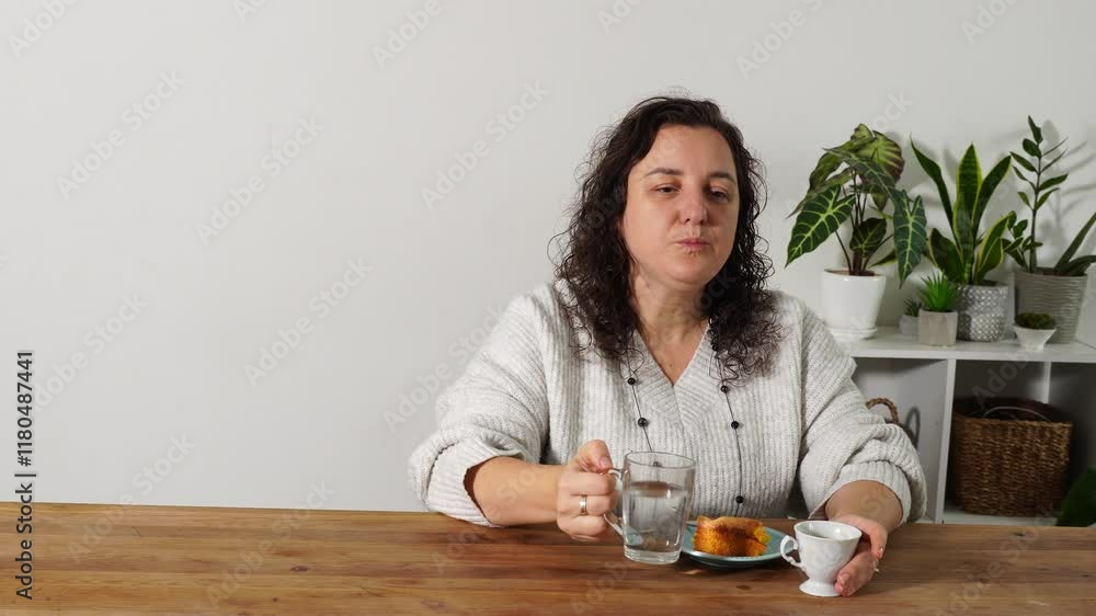 Woman eats breakfast at the kitchen Woman eats breakfast at the kitchen