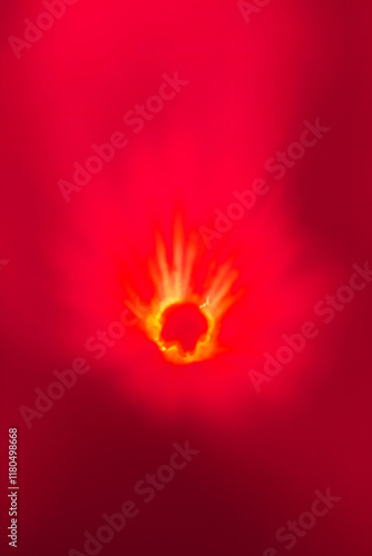 Abstract Image of a Glowing Red Background with a Bright Yellow and Orange Burst Resembling Fire or Light Radiating from the Center