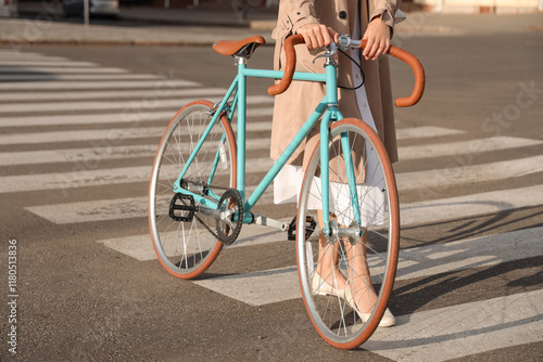 Young woman with bicycle wa...