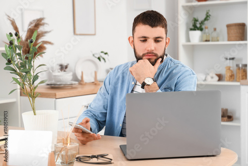 Young bearded man working w...