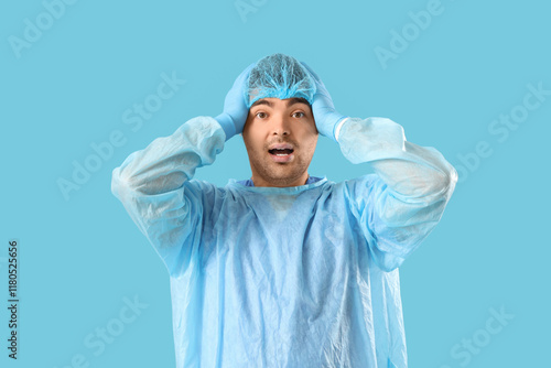 Stressed male doctor on blu...