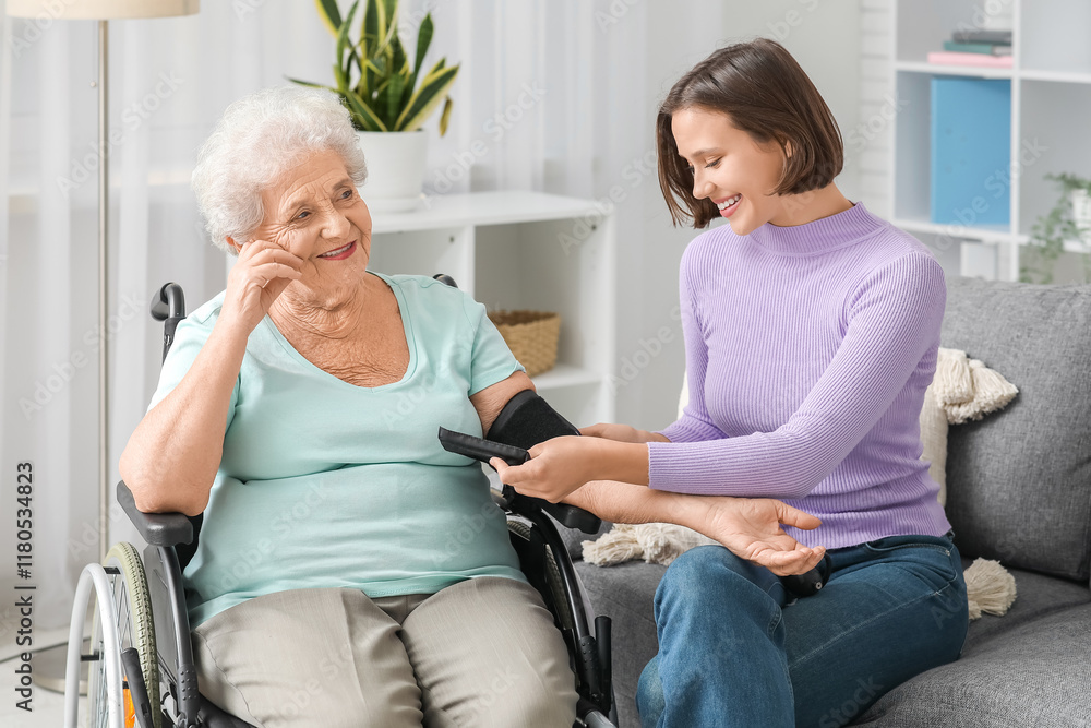© Pixel-Shot - Senior woman in wheelchair with nurse measuring blood pressure at home © Pixel-Shot - Senior woman in wheelchair with nurse measuring blood pressure at home