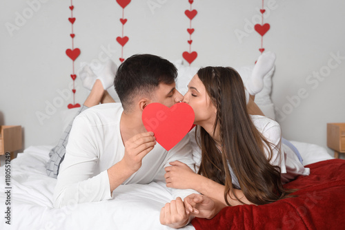 Young couple kissing behind...