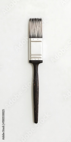 Single paintbrush with dark handle on white background. photo