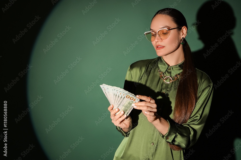 Young woman with dollar banknotes on green background Young woman with dollar banknotes on green background