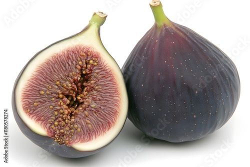 Two ripe figs close together on a pure white background, one fig is cut in half to show it off photo