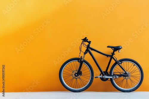 Wallpaper Mural Black Mountain Bike Stands Out Against Vibrant Yellow Wall for Urban Cycling Adventures Torontodigital.ca