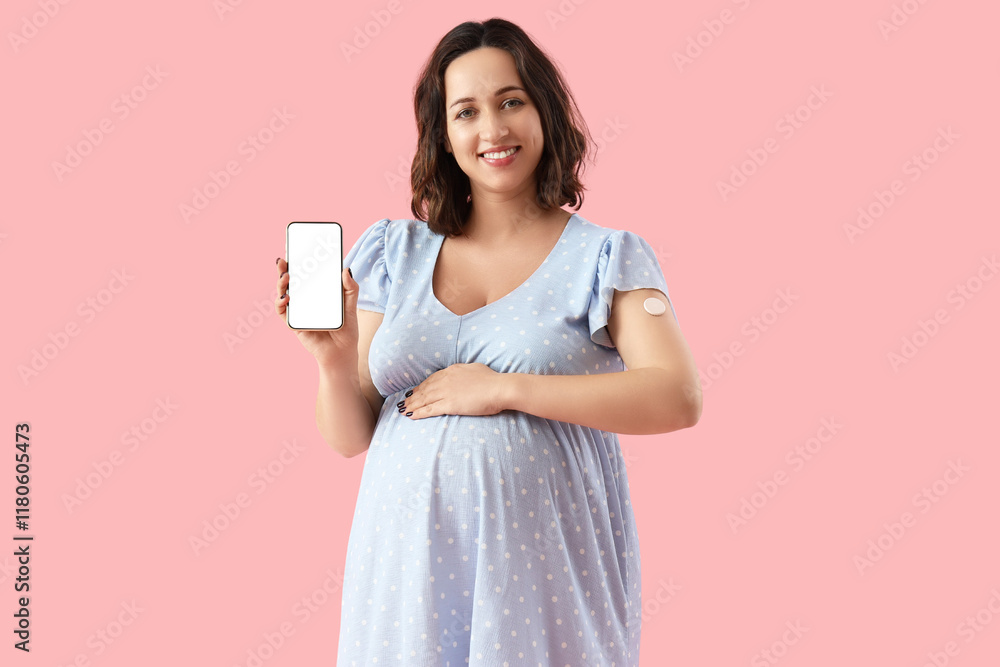 Young pregnant woman with glucose sensor and mobile phone on pink background. Gestational diabetes concept Young pregnant woman with glucose sensor and mobile phone on pink background. Gestational diabetes concept
