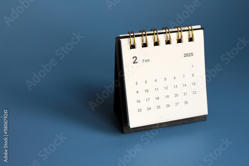 Monthly calendar template for the new year 2025 desk calendar,isolated on Blue background. photo