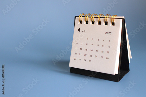 Monthly calendar template for the new year 2025 desk calendar,isolated on Blue background. photo