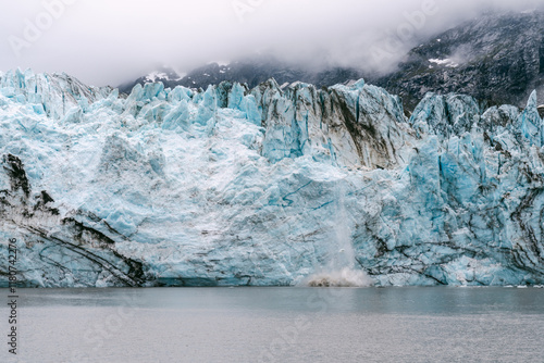 Ice calving off Johns Hopkins Glacier in Glacier Bay National Park in southeast Alaska  photo