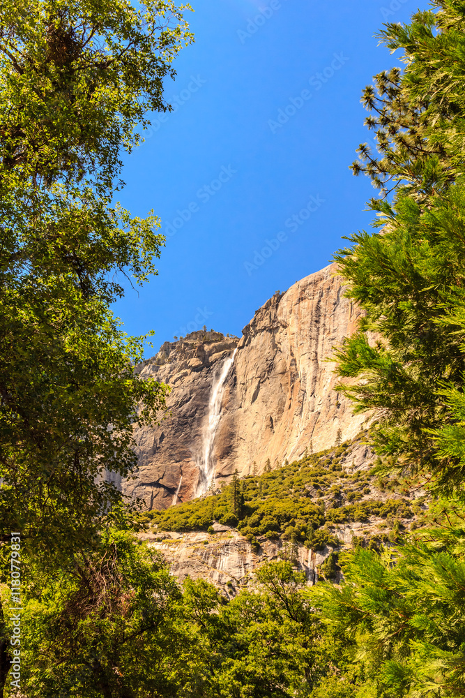 A mountain with a waterfall in the foreground A mountain with a waterfall in the foreground