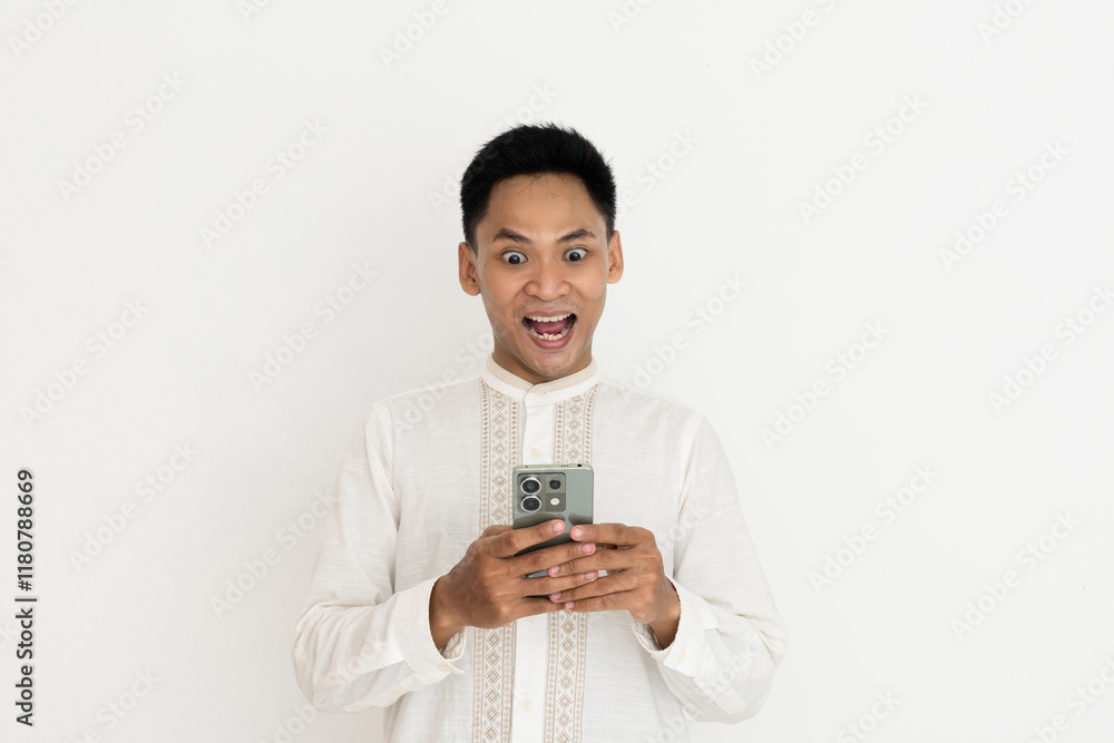 man wearing elegant traditional clothing looks excited while holding a smartphone, expressing amazement and curiosity at what he sees. man wearing elegant traditional clothing looks excited while holding a smartphone, expressing amazement and curiosity at what he sees.