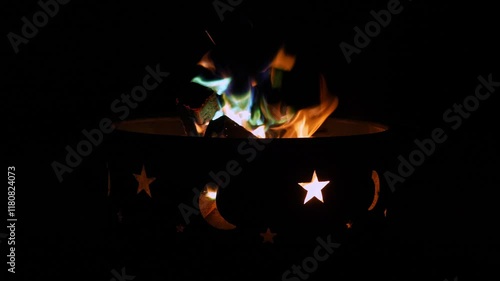 Bonfire fire pit with sky stars cutouts at night camping. Beautiful flame with different color. High quality 4k footage