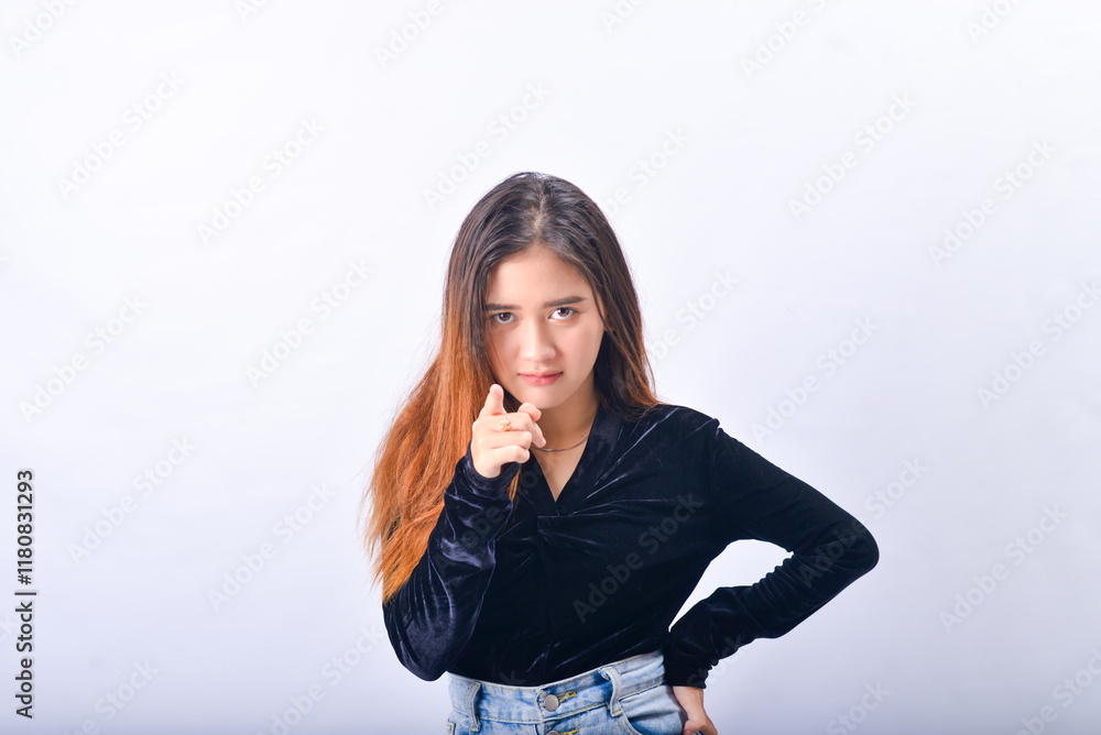 A young Asian Woman in a Black Velvet Top and Denim Jeans making expressive gestures Isolated on white background A young Asian Woman in a Black Velvet Top and Denim Jeans making expressive gestures Isolated on white background