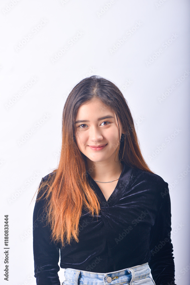 A young Asian Woman in a Black Velvet Top and Denim Jeans making expressive gestures Isolated on white background A young Asian Woman in a Black Velvet Top and Denim Jeans making expressive gestures Isolated on white background