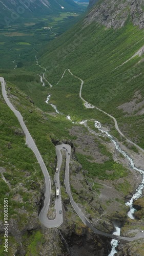 Trollstigen, Andalsnes, Norway. Cars Goes On Serpentine Mountain Road Trollstigen. Famous Norwegian Landmark And Popular Destination. Norwegian County Road 63 In Summer Day. photo