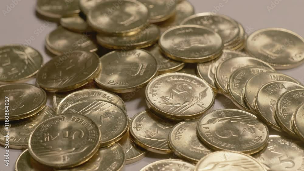 indian currency golden 5 rupee coins scattered on the table , 4k ,close up, orbit shot indian currency golden 5 rupee coins scattered on the table , 4k ,close up, orbit shot