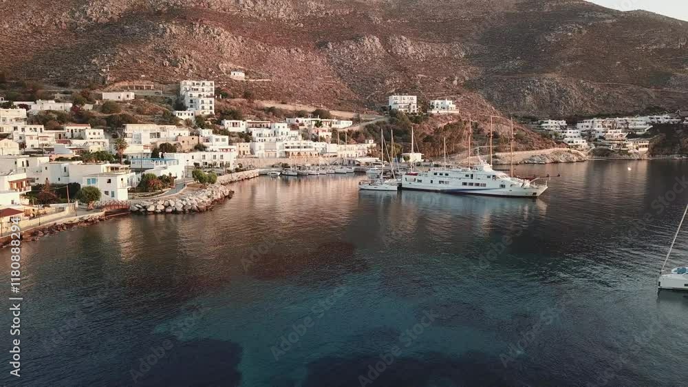 Greece,Tilos Island,Aerial view of Harbour and village,backwards towards crystal clear turquoise bay. Greece,Tilos Island,Aerial view of Harbour and village,backwards towards crystal clear turquoise bay.