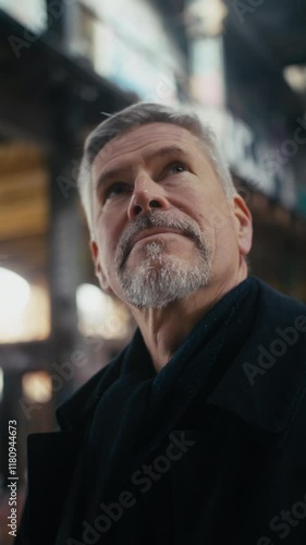 Portrait of middle aged man looking around an abandoned building.
