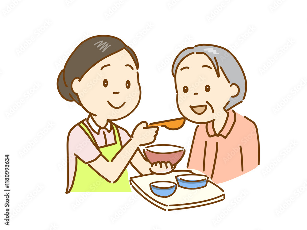 介護士が食事介助をする。笑顔の高齢者 介護士が食事介助をする。笑顔の高齢者