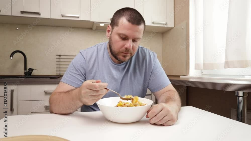 Man Eating Fresh fruit salad, relaxing at home with natural ingredients, showcasing a fresh and healthy lifestyle. Man Eating Fresh fruit salad, relaxing at home with natural ingredients, showcasing a fresh and healthy lifestyle.