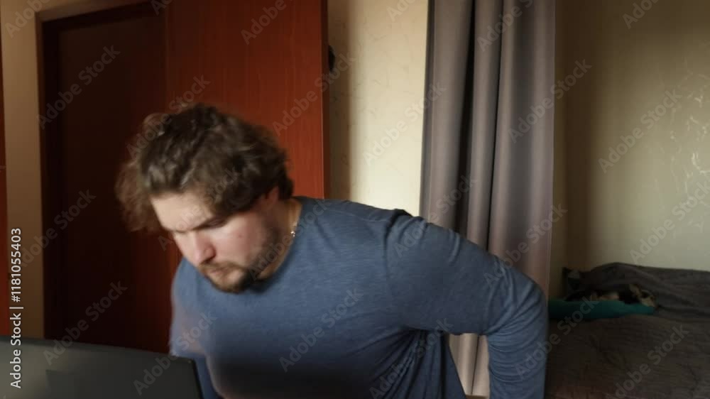Angry man working on laptop, annoyance with internet problems, modern desk in home office. Angry man working on laptop, annoyance with internet problems, modern desk in home office.