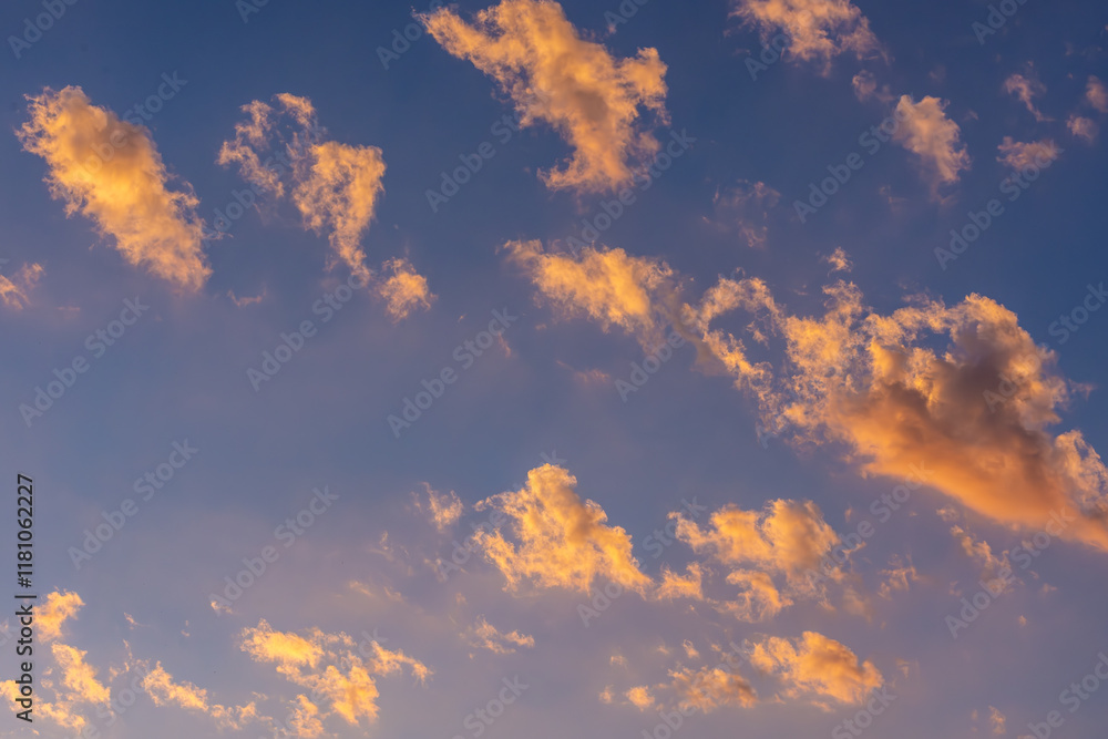 Clouds Reflect the Early Morning Sun, Painting Orange and Yellow Clouds Against a Pink and Blue Sky. Clouds Reflect the Early Morning Sun, Painting Orange and Yellow Clouds Against a Pink and Blue Sky.