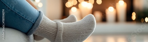 Cozy scene with knitted socks resting on a surface, soft bokeh effect from glowing candles in the background, Ideal for themes of relaxation, comfort, and home life in lifestyle or holiday content, photo