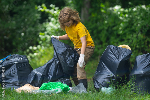 Canvas Print Child boy picking up plastic bottle outdoor