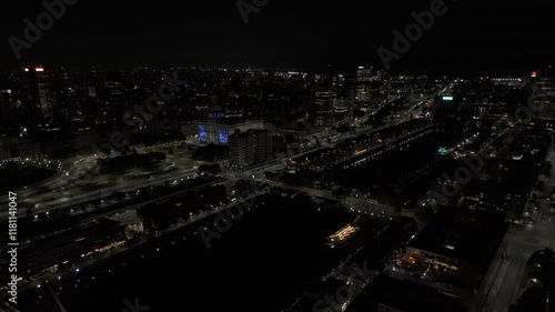 Wallpaper Mural Drone flies over Rio Darsena Sur toward Palacio Libertad, Centro Cultural Domingo Faustino Sarmiento at night in Buenos Aires, Argentina Torontodigital.ca