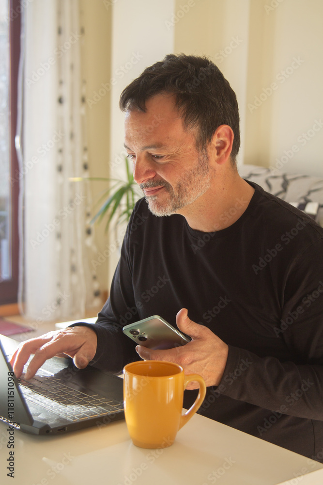 mature man working with pc and phone at home or workplace mature man working with pc and phone at home or workplace
